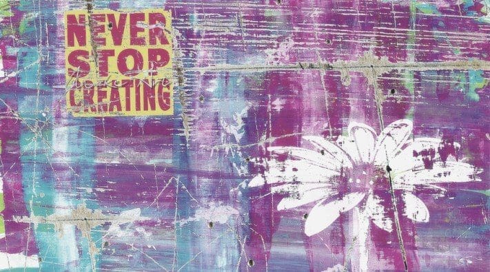 A mixed media artwork featuring the text "Never Stop Creating" in yellow and red over a textured background with a large, white, stylized flower.