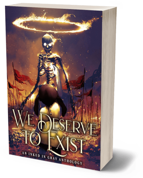 3D render of the book 'We Deserve to Exist,' an Inked in Gray anthology. The cover features a haunting, otherworldly image of a skeletal figure with glowing eyes, standing amidst a field of red flags. The figure is illuminated by a glowing, fiery halo above its head, casting an eerie light across the scene. The sky is dark and ominous, with swirling clouds and sparks of light, adding to the apocalyptic atmosphere. The title 'We Deserve to Exist' is written in large, elegant gold letters at the bottom, with the subtitle 'An Inked in Gray Anthology' beneath it in smaller text. The cover evokes themes of survival, defiance, and the struggle for existence in a dystopian or supernatural setting.
