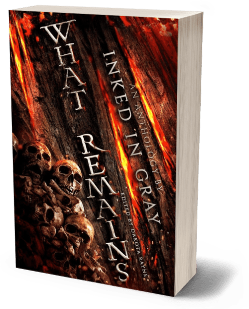 3D render of the book 'What Remains,' an anthology by Inked in Gray, edited by Dakota Rayne. The cover features a dark, eerie scene with a pile of skulls and bones in the foreground, set against a textured background that appears to be a charred or burned surface, with fiery red and orange streaks running vertically. The title 'What Remains' is written in bold, distressed white text along the left side, with the words 'An Anthology by Inked in Gray' running vertically on the right. The overall design evokes a sense of horror, decay, and the remnants of destruction, fitting the grim and ominous tone of the anthology.